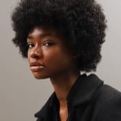 Profile picture of a black woman with afro hair.